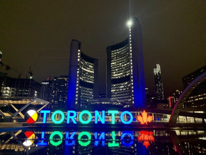 City of Toronto sign in the dark lit blue and green