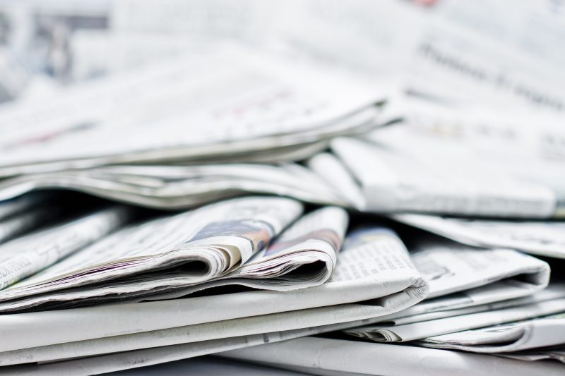 A pile of scattered newspapers.