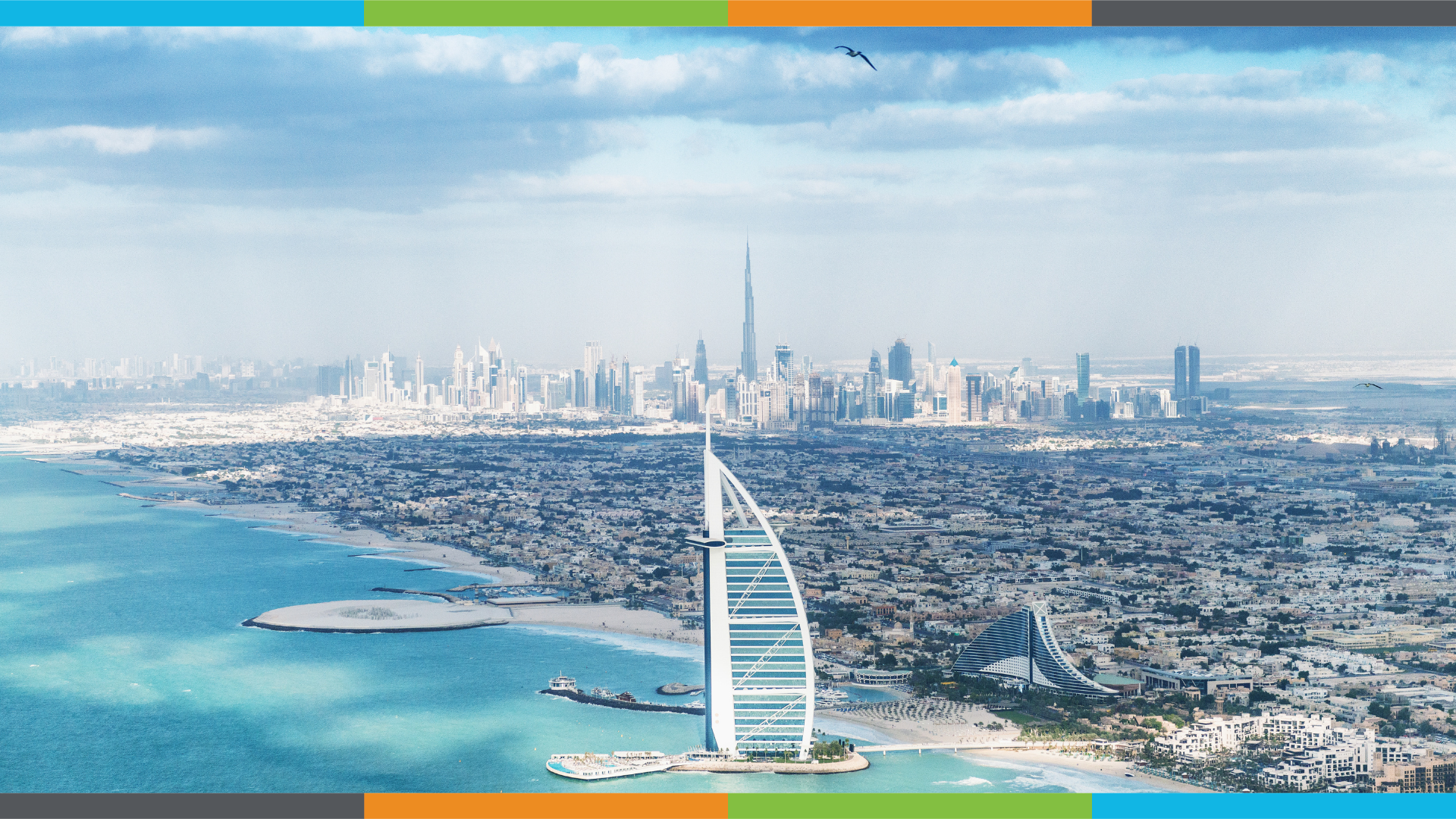 The coast of Dubai, nestled against cerulean waters, on a beautiful day. Some clouds create a haze high in the sky. A border of Circular Innovation Council's brand colours runs along the top and bottom.