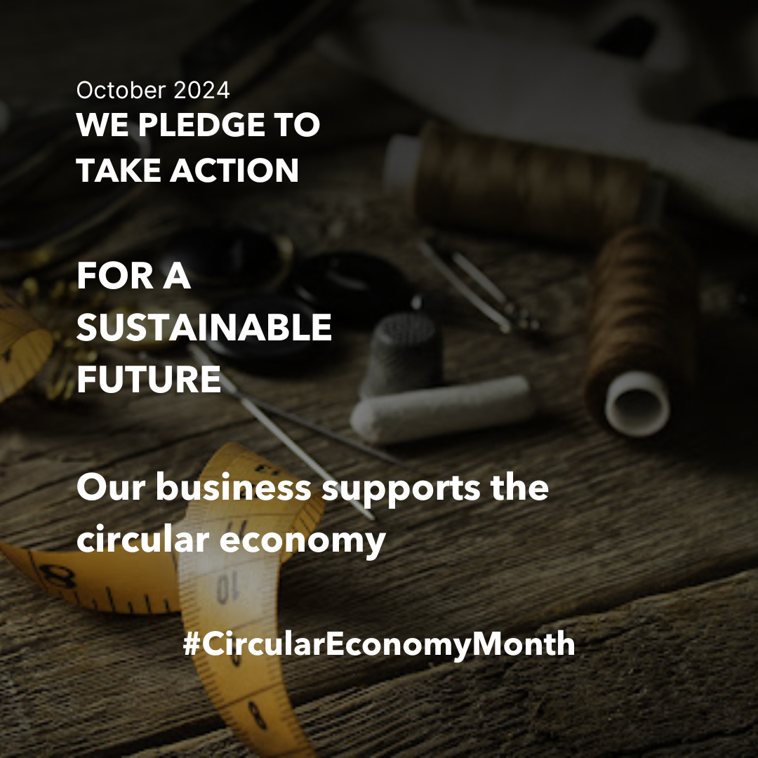 A tailor's supplies, including thread, measuring tape, chalk, and thimble rest on the surface of a wooden desk. October 2024. We pledge to take action for a sustainable future, Our business supports the circular economy. #circulareconomymonth